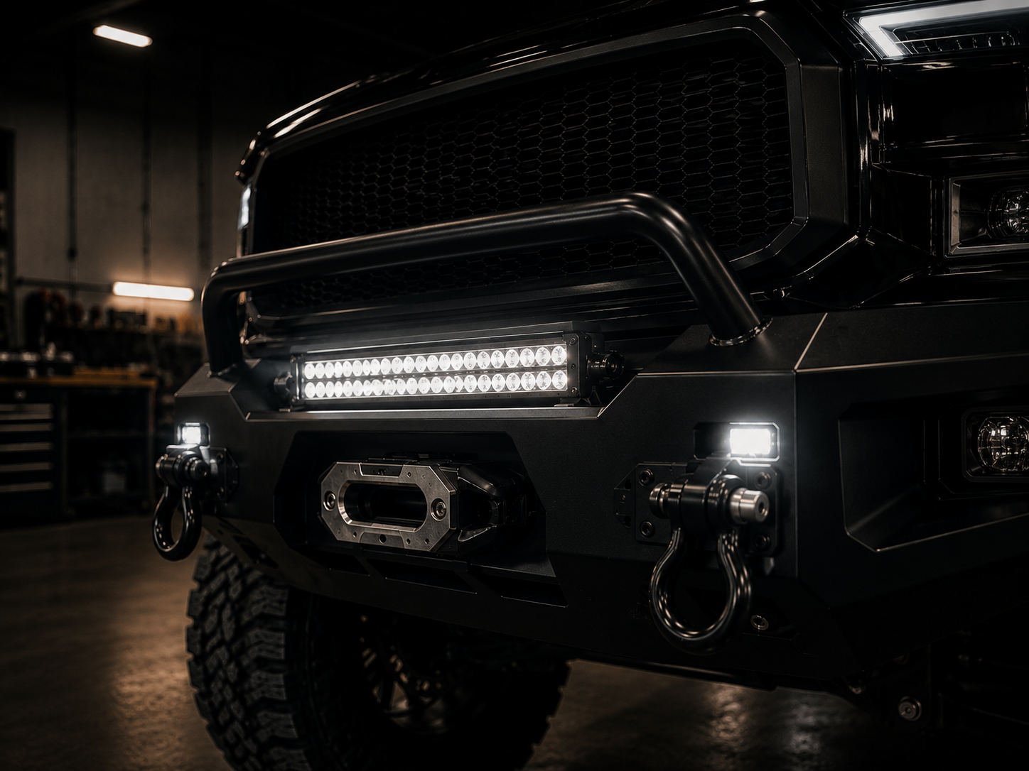 LED light bar and auxiliary lights installed on a truck's aftermarket bumper at Adams Auto Restyling in Windsor, CO